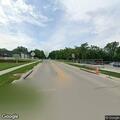 Officer checks parked vehicle at intersection