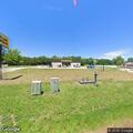 Officer checks white pickup at Dollar General