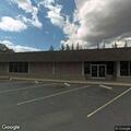 Person experiencing chest pain in front of bank
