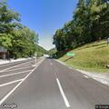 Car driving close to pedestrians on roadway