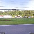 Fallen phone line blocking roadway near pizza shop