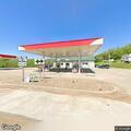 Officer checks vehicle at gas station in Tuscumbia