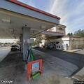 Person receiving medical aid with law enforcement at gas station