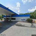 Woman conscious with breathing difficulty behind gas pump