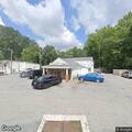 Adult experiencing chest pain at auto repair shop