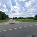 Person on ground in front of high school on Leonardtown Road