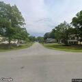 Person experiencing severe back pain at residence