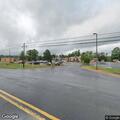 Person with walking stick nearly hits car in roadway