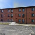 Person experiencing abdominal pain at apartment lobby