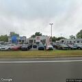 Two-car crash with three injured near car dealership