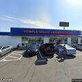 Person experiencing back pain near laundry at Branch Ave