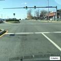 Elderly woman walking in road against traffic