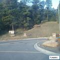 Motorcycle speeds away from park gate