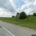 Motorcycle stop for suspended plate at gas station