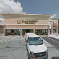 Tow truck blocks delivery truck behind store