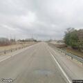 Pedestrian walking on shoulder of US 14 in Eyota