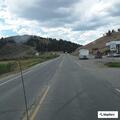 Elderly woman walking along Highway 24 in Hartsel