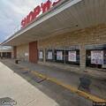 Car leaking fuel in grocery store parking lot