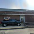 Person sitting by dumpster at McDonald's refused help