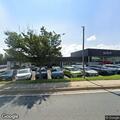 Intoxicated man stumbling in car dealership lot