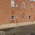 Car with broken window and flat tire on street