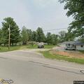 Officer checks suspect vehicle at trailer park