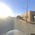 Dumpster fire near building in locked area on Clay