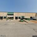 Dumpster fire against building at Northwest Plaza