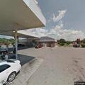Traffic stop on silver car near gas station