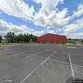 Person seen walking around parked SUV on business lot