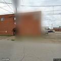 Unwanted person sleeping outside white building