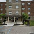 Group carries man from apartment, lingers at door