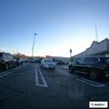 Traffic stop with gray Hyundai at grocery lot