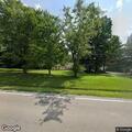 Car leaves roadway and stops in yard on State Road 135