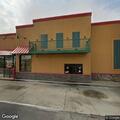Person walking with gas can near Popeyes