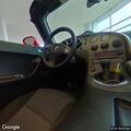 Person on scooter looking into cars in lot