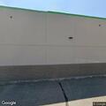 Officer checks person behind Dollar Tree