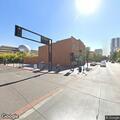Couple arguing and man punching trash can downtown