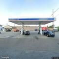 Man slumped in running car on roadway near local store
