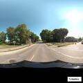 Female driver flailing arms and head in car at intersection