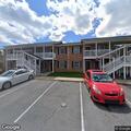 Person experiencing abdominal pain at Pinewood Court