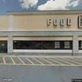 Abandoned car with open trunk at grocery store