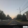 Officer checks person walking near Country Inn