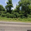 Disabled vehicle with flat tire blocking roadway