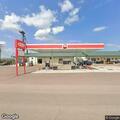 Man asking customers for money at gas station