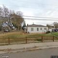 Person experiencing back pain at Aurora residence