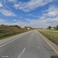 Motorist assist for red convertible on I-35 median