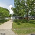 Car door left open on SUV in driveway