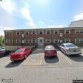 Person experiencing abdominal pain at apartment complex