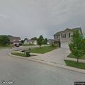 Woman knocking on door at Greenfield home